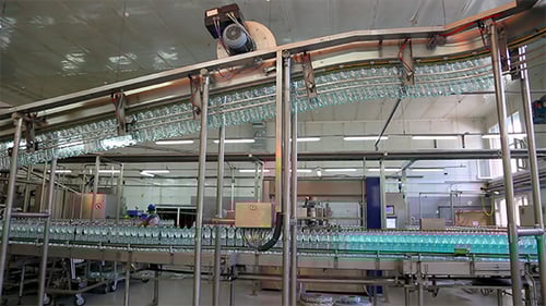 Water Bottles Moving on Conveyor Belt in Factory