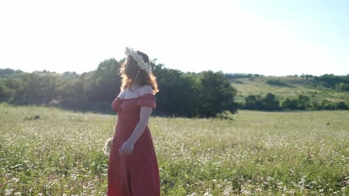 Beautiful Young Woman in Chamomile Field