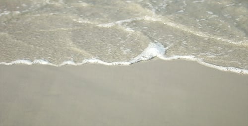 Gentle Waves Washing over Sandy Beach