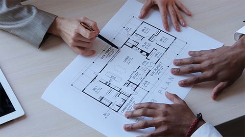 Real Estate Broker Showing Apartment Plan