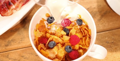 Appetizing Breakfast: Orange Juice, Eggs, Bacon, and Cereal