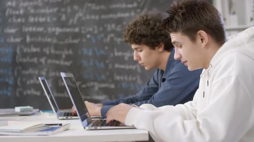Boys Chatting At Computer Class