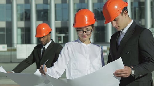 Engineers Discussing Plans in front of Building