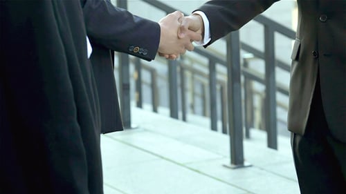 Corporate Business People Meeting and Shaking Hands Outdoors