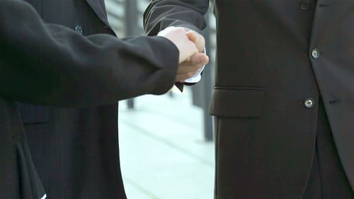 Businessmen Handshake In An Urban Environment