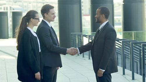 Business People Meeting and Handshake Outdoors