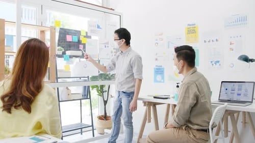 Business Colleagues Presenting Data in Modern Office