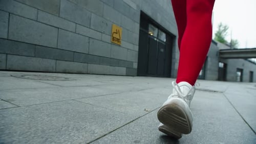 Woman Legs Running on Street in Slow Motion. Close Up Female Runner Legs Jogging