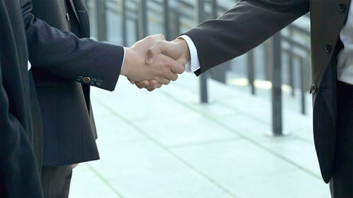 Business People Shake Hands After Successful Meeting