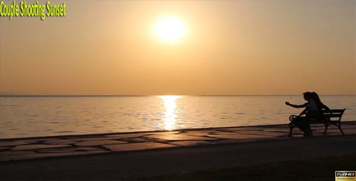 Couple Enjoying Sunset by Ocean