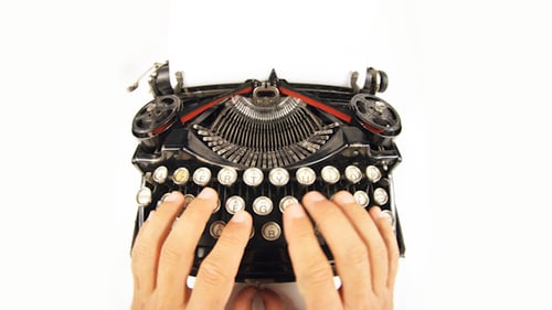 Hands Typing on a Vintage Typewriter
