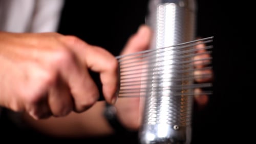 Playing a Metal Guiro Instrument with Scraper