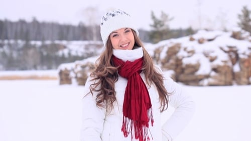 Young Woman Smiling in Snowy Winter Park