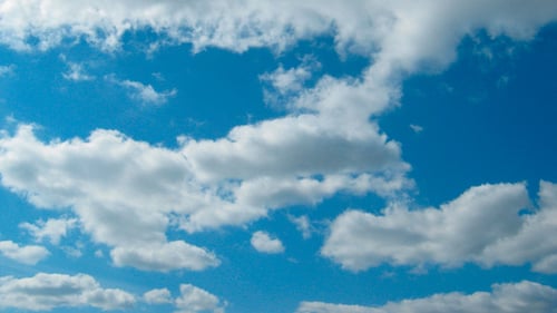 Clouds Drifting Slowly Through Blue Sky