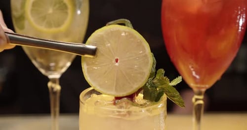 Bartender Decorating Spicy Cocktail with Lemon Slice