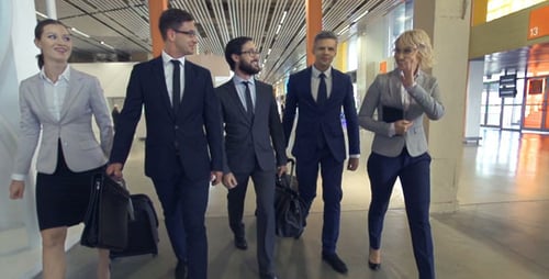 Business Team Confidently Walking in Modern Terminal