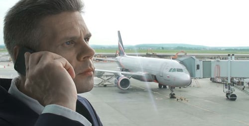 Man Talking on Phone Near Aeroflot Airplane at Airport