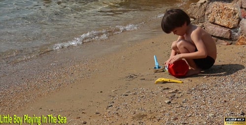 Little Boy Playing In The Sea
