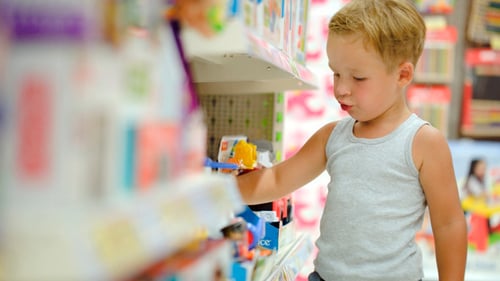 Boy Watching Toys In The Shop