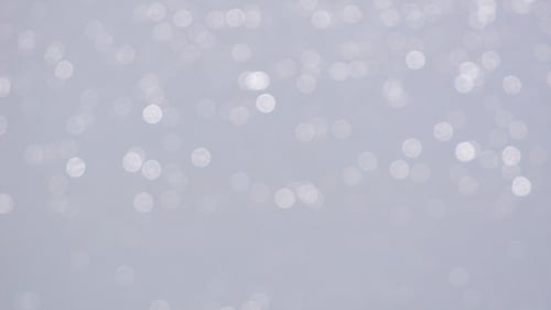 Shimmering Bokeh Lights on Light Gray Background