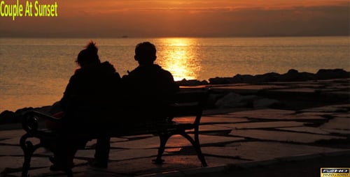 Couple Enjoying a Sunset on the Beach