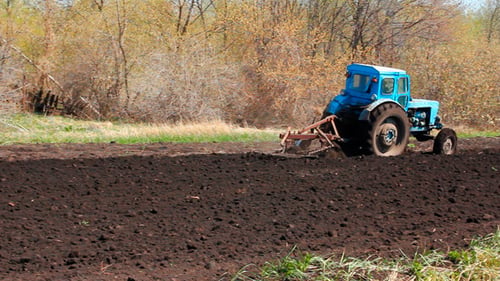 Tractor Plowing At Spring