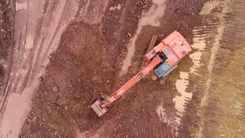 Excavator Working in the Mud, Aerial Shot