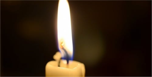 Candle Flame Brightly Burning in the Dark