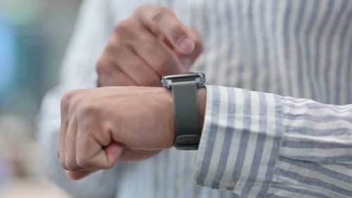 Close Up of African Man Using Smart Watch