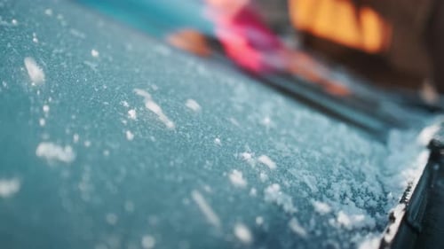 Clearing Ice Off Car Windshield in Winter