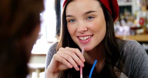 Woman having a drink with a straw