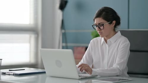 Indian Businesswoman having Wrist Pain while using Laptop in Office