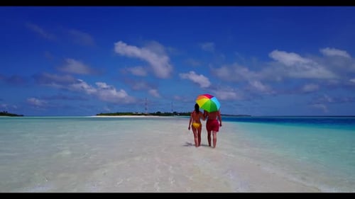 Young couple engaged on perfect bay beach vacation by blue ocean and white sandy background of the M
