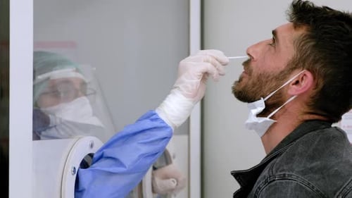 Man Receives Nasal Swab from Medical Professional