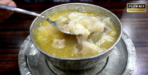 Close up stirring meat broth soup