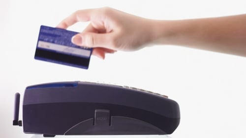 Hand Swiping Credit Card Through Pin Pad