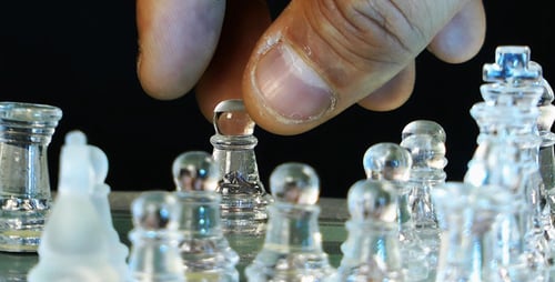 Hand Moves Chess Piece on Chessboard Close Up