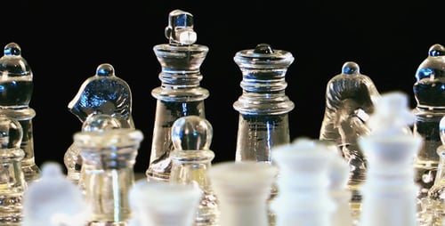 Glass Chess Pieces on Chessboard Close Up
