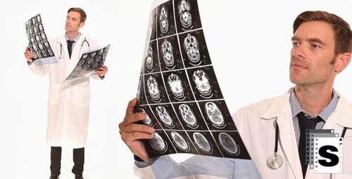Thoughtful Doctor Examining Brain Scan Images