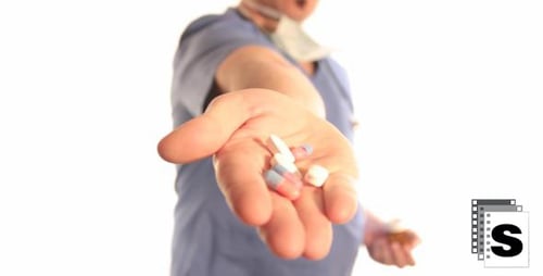 Doctor Presents Pills in Hand