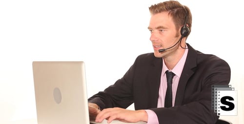 Man in Suit using Laptop with Headset