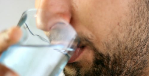 Man Drinks Refreshing Water in Close Up Studio