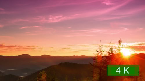 Mountain Sunrise Over Forested Hills
