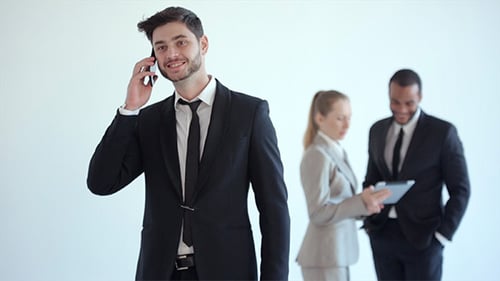 Businessman Talks on the Phone and Hears Good News