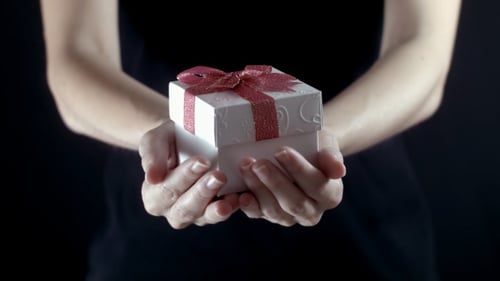 Holding a Small Gift Box with Red Ribbon