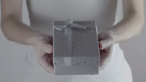 Woman Presents a Small Gift