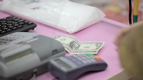Client Paying With Cash In Pharmacy