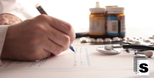 Medical Professional Writes Prescription in Bright Office