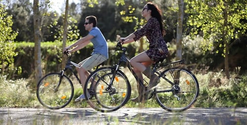 Couple Riding Bicycles on Countryside Path