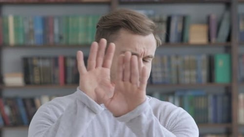 Man Holds Hands Up to Say No